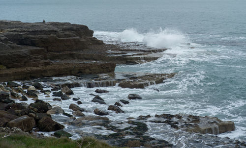 Waves splashing on rocks at shore