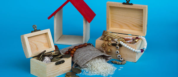 Close-up of toys on table against blue wall