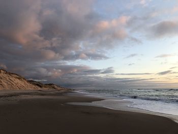Scenic view of beach against sky during sunset