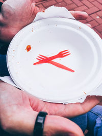 Midsection of person holding red cake