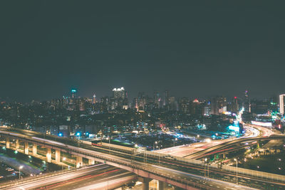 High angle view of illuminated buildings against sky at night