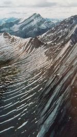 Aerial view of snowcapped mountains against sky