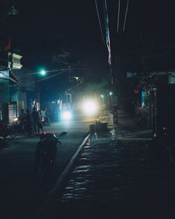 People on illuminated street at night