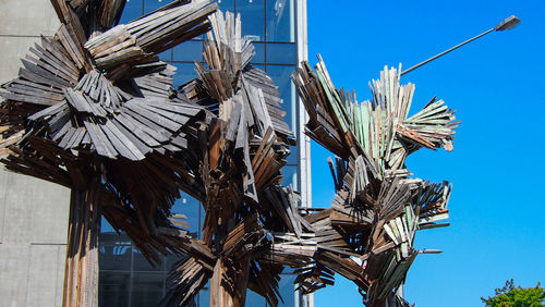 Low angle view of palm tree against blue sky