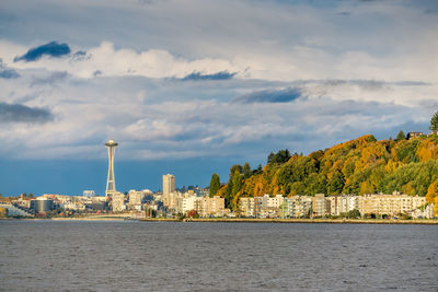 A view of condos at alki beach and the seattle skyline.