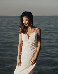 Young woman standing in sea