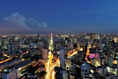 High angle view of illuminated city buildings against sky