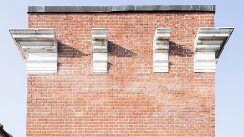 Low angle view of brick building against sky