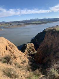 Scenic view of sea and mountains against sky
