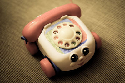 High angle view of chatter telephone toy on carpet