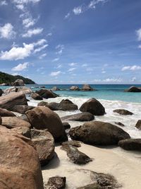 Rocks on beach against sky