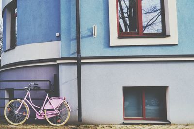 Bicycle by window of building