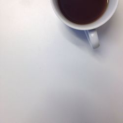 Close-up of coffee cup on white background