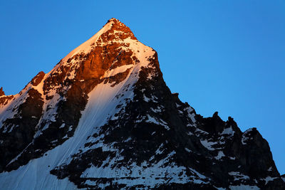 Low angle view of snowcapped mountain at gran paradiso national park