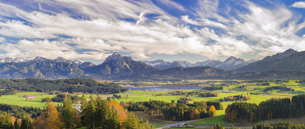 Scenic view of field and mountains against sky