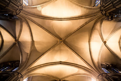 Directly below shot of illuminated ceiling in church