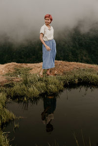 Full length of man standing by lake