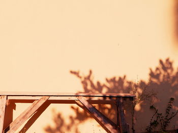 Close-up of railing against sky during sunset