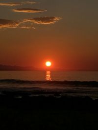 Scenic view of sea against romantic sky at sunset