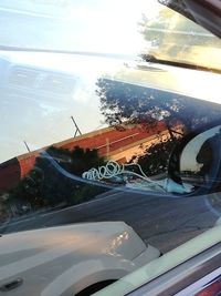 Close-up of car on road against sky