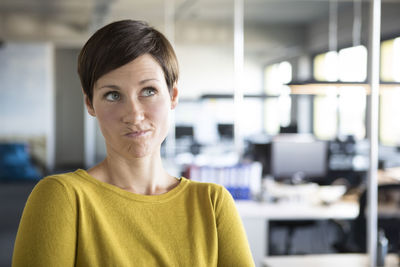 Businesswoman in office thinking