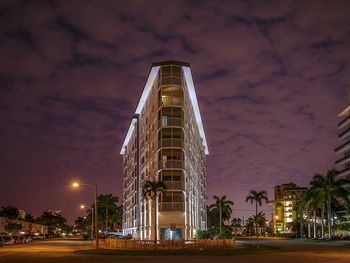 Low angle view of illuminated building against sky at night