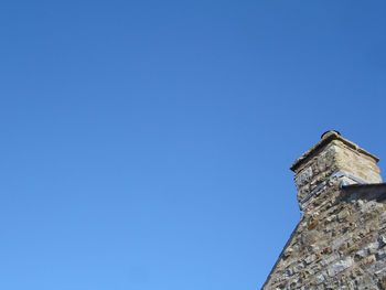 Low angle view of built structure against clear blue sky