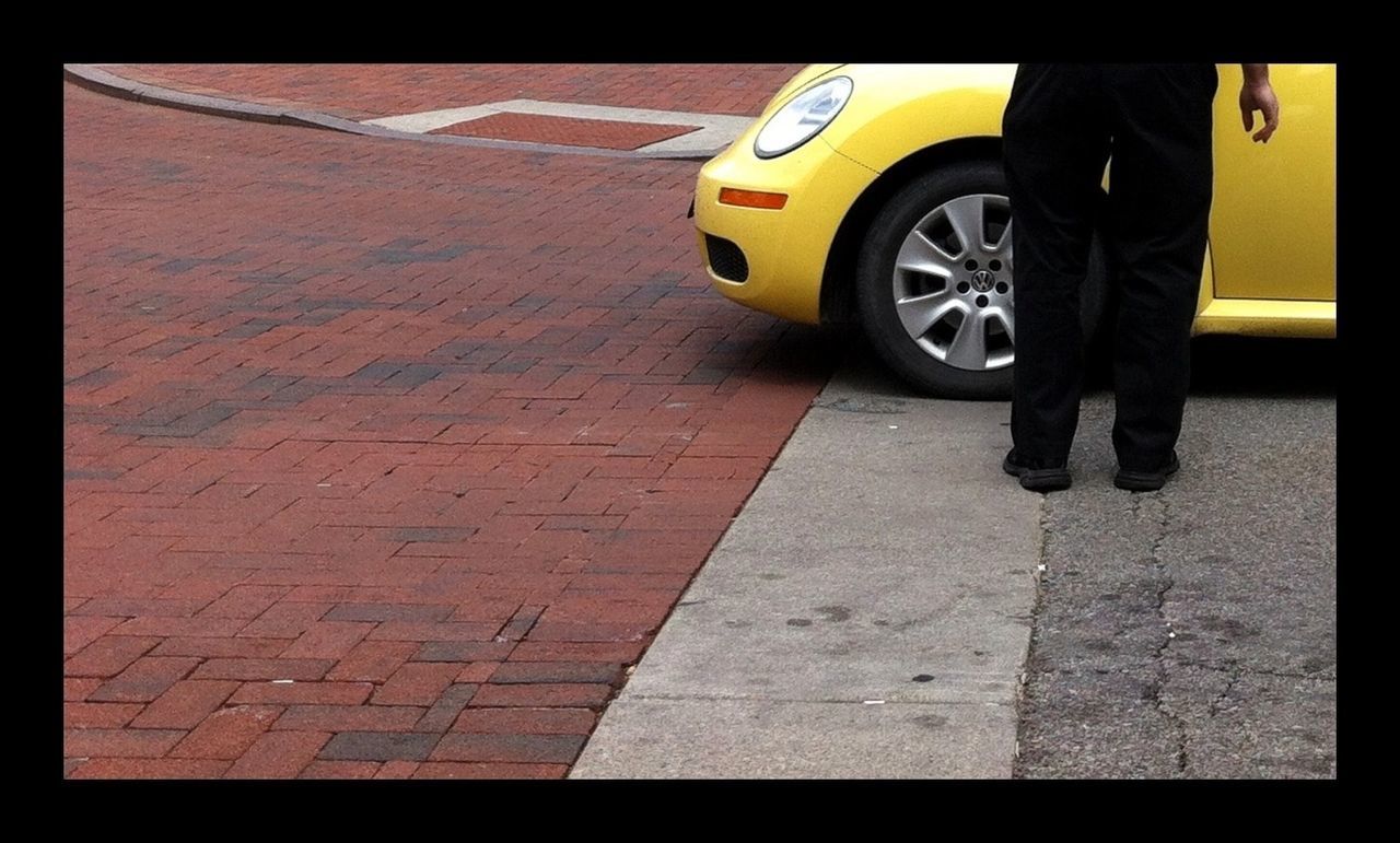 transportation, transfer print, mode of transport, land vehicle, street, auto post production filter, car, road, road marking, travel, bicycle, on the move, yellow, sidewalk, stationary, outdoors, sunlight, cobblestone, shadow, day