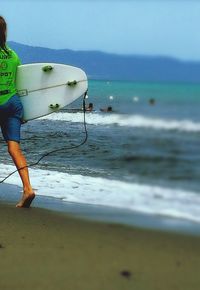 Man standing on beach against sky