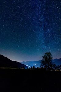 Scenic view of silhouette landscape against star field at night