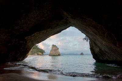 Scenic view of sea seen through cave