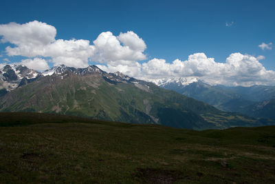 Scenic view of mountains against cloudy sky