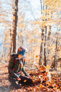 Rear view of woman standing in forest