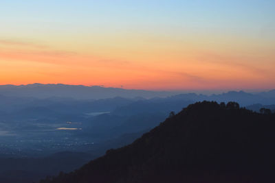 Scenic view of silhouette mountains against sky during sunset