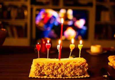 Lit candles on birthday cake