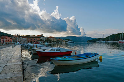 Boats moored in sea against sky