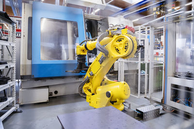 Robotic arm in front of machine