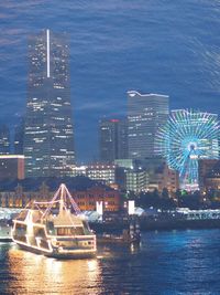 Illuminated buildings in city at waterfront