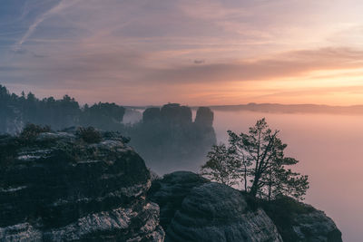 Scenic view of rock formation against sky during sunset