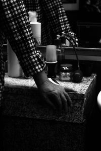 Midsection of woman holding drink at table