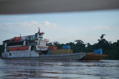 Fishing boat in sea against sky