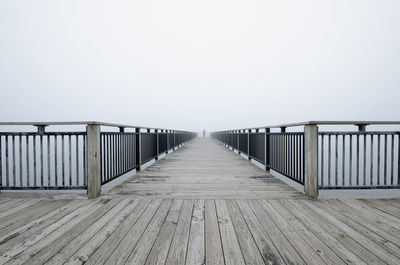 Pier on sea against clear sky
