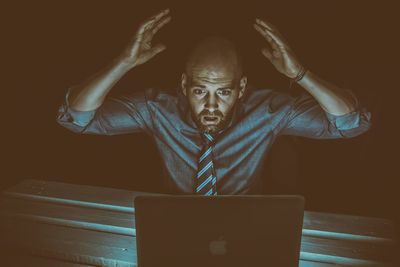 Midsection of man using smart phone on table