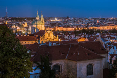 Illuminated buildings in city against sky at night