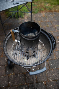 High angle view of barbecue chimney on grill 