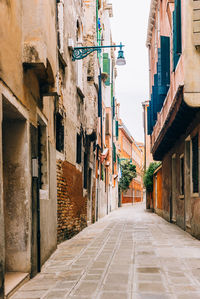 Narrow alley amidst buildings in city