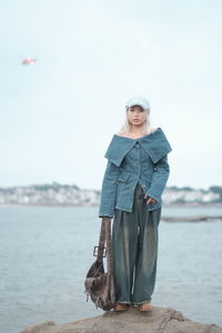 Low section of woman standing against clear sky