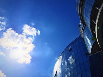 Low angle view of modern building against blue sky