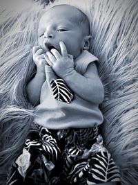 Close-up of cute baby sleeping on bed