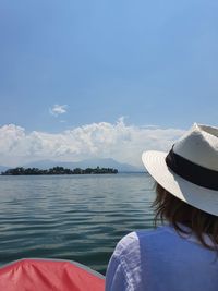 Rear view of woman looking at sea against sky